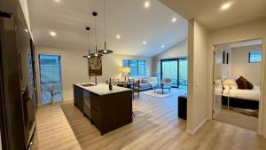 a kitchen and living room with a sink and a living room at Luxurious Stay with Mountain Views in Queenstown