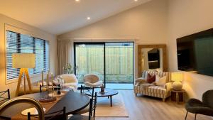 a living room with a couch and a table at Luxurious Stay with Mountain Views in Queenstown