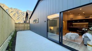 an external view of a house with a patio at Luxurious Stay with Mountain Views in Queenstown
