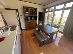 eine Küche mit Tisch und Stühlen in einem Zimmer in der Unterkunft MIYABI stay house in Tamana