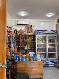 a kitchen with a refrigerator with food in it at Tirso and Nora's Inn in General Luna