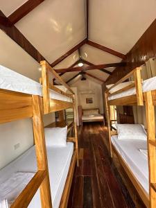 a room with three bunk beds in a house at Tirso and Nora's Inn in General Luna +73 photos
