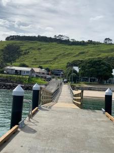 a wooden bridge over a body of water at Beach view studio 337 in Omapere