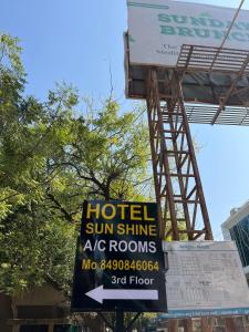 a sign for a hotel sun shine sig rooms at Hotel Sun Shine in Jāmb