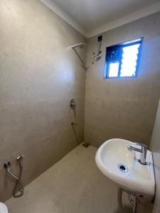 a bathroom with a sink and a window at Hotel Sun Shine in Jāmb