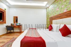 a hotel room with a bed and a desk at Olivia Hotels - Delhi Airport in New Delhi