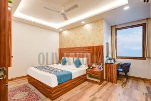 a hotel room with a bed and a window at Olivia Hotels - Delhi Airport in New Delhi