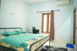 Ένα ή περισσότερα κρεβάτια σε δωμάτιο στο Batukaras beach hill