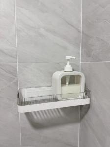 a white urinal on a wall in a bathroom at 79Hotel Rayong in Ban Hua Phrong