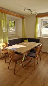 a dining room with a wooden table and chairs at Ferienwohnung Stabentheiner in Simmerlach