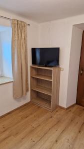 a living room with a tv on a stand at Ferienwohnung Stabentheiner in Simmerlach