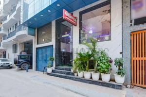 a store front with pots of plants outside of it at Olivia Hotels - Delhi Airport in New Delhi