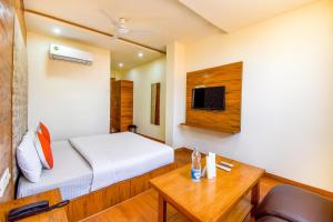 a hotel room with a bed and a table and a tv at Hotel Black Diamond, Patiala Chok 2 min from Zirakpur Bus Stand near Panchkula in Zirakpur
