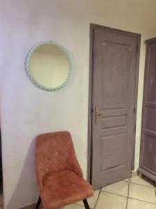 una sedia in una stanza con specchio e porta di Centre ville a Tarascona