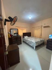 a bedroom with a bed and a dresser and a mirror at La Ureña House in La Ureña