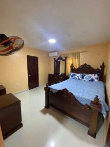a bedroom with a bed and a dresser in it at La Ureña House in La Ureña