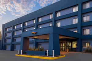 a blue office building with a blue at Baymont by Wyndham Davenport in Davenport