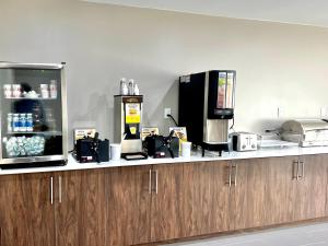 a kitchen with a counter top with a coffee maker at Hawthorn Extended Stay by Wyndham Jackson in Jackson