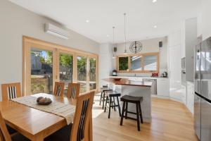 a kitchen and dining room with a table and chairs at Poets View - 3 Bedroom House in West Hobart