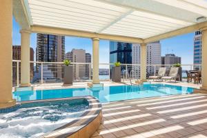 a swimming pool on the roof of a building at Mantra 2 Bond Street in Sydney