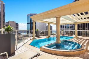 a swimming pool on the roof of a building at Mantra 2 Bond Street in Sydney