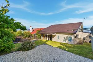 a house with a gravel yard in front of it at Poets View - 3 Bedroom House in West Hobart