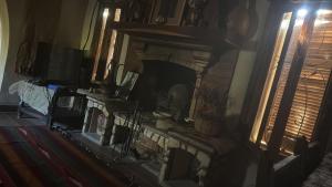 a living room with a fireplace and a window at Paloma Wooden House !!! in Siwa
