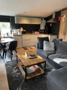 a living room with a couch and a table at La Luna in Lanaken +9 photos