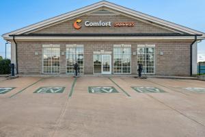 a building with a store with a sign on it at Comfort Suites Conway in Conway