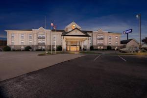a large building with a flag in front of it at Comfort Suites Conway in Conway