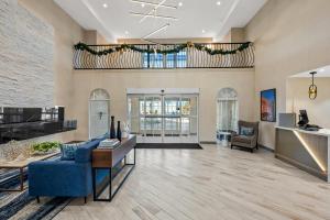 a living room with a blue couch and a table at Comfort Suites Conway in Conway +64 photos