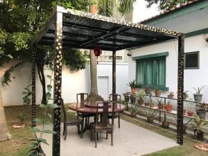 a patio with a table and chairs under a pergola at Lai Ming Hotel Cosmoland in Singapore