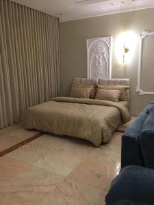 a bedroom with a large bed in a room at Big studio apartment in Makkah