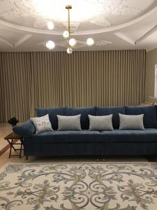 a blue couch sitting in a living room at Big studio apartment in Makkah