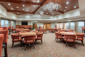 a conference room with tables and chairs and a podium at Norfolk Lodge & Suites, an Ascend Collection Hotel in Norfolk +55 photos