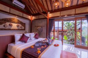 Postel nebo postele na pokoji v ubytování Mahadana Ubud + 54 fotografií