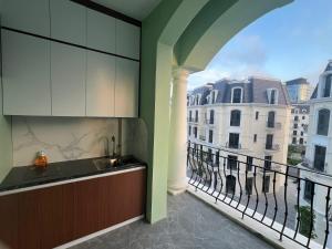 a kitchen with a sink and a balcony at Kapás Hotel in Hai Phong