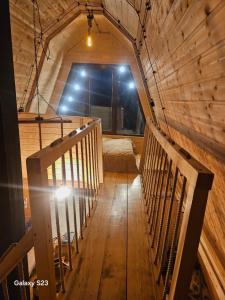 una camera mansardata con scala in una casa di legno di twin cottages a Goderdzi