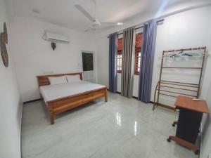 a bedroom with a bed and a ladder and a desk at Relax inn modara in Mirissa