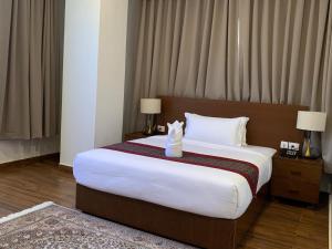 a hotel room with a large bed with a box on it at Hotel pema raga in Thimphu