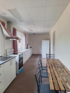 a kitchen and dining room with a table and chairs at Adelaide Free Souls in Adelaide