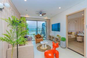a living room with a view of the ocean at Căn Hộ The Song - Po's Homestay in Vung Tau