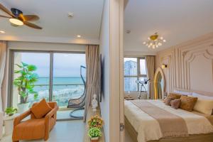 a bedroom with a large bed and a large window at Căn Hộ The Song - Po's Homestay in Vung Tau +100 photos