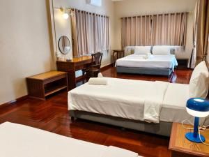 Postel nebo postele na pokoji v ubytování Suansin Garden Hotel โรงแรมสวนสินการ์เด้น