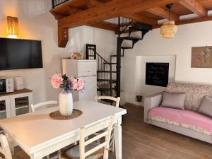 a living room with a table and a couch at Guest House Little Flower in Sutri
