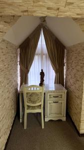 a room with a desk and a chair and a window at Чумацький табір in Dryglov