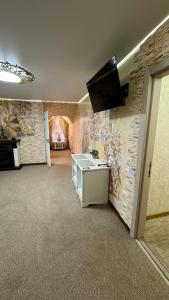 a room with a wall with a tv on it at Чумацький табір in Dryglov