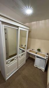 a room with a closet with a large glass door at Чумацький табір in Dryglov +17 photos