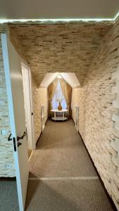 a hallway with a room with a bed and a window at Чумацький табір in Dryglov