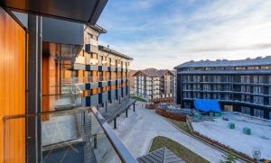 an apartment balcony with a view of a courtyard at NEO Skyview Suites in Gudauri